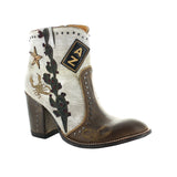 A pair of women's boots with a milk/khaki color scheme, featuring embroidery and a star design on the upper, with a brown sole and heel.