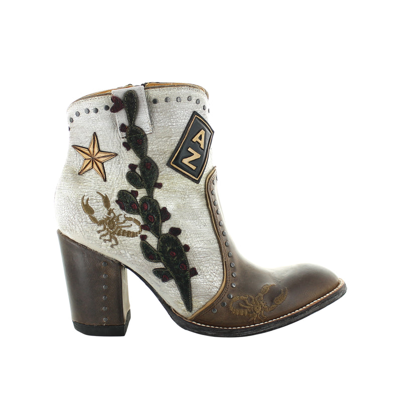 A pair of women's boots with a milk/khaki color scheme, featuring embroidery and a star design on the upper, with a brown sole and heel.