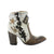 A pair of women's boots with a milk/khaki color scheme, featuring embroidery and a star design on the upper, with a brown sole and heel.