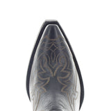 Close-up of a cowboy boot with intricate stitching on a white background