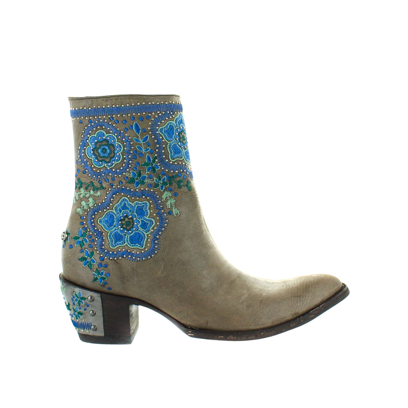 A grey-colored women's boot with embroidered detailing on the toe and heel.