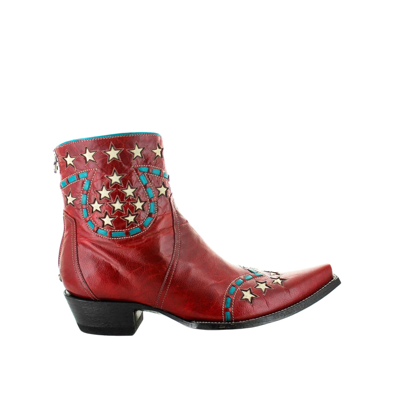 A red leather women's boot with decorative braiding and a star design on the toe and heel, with a black sole.