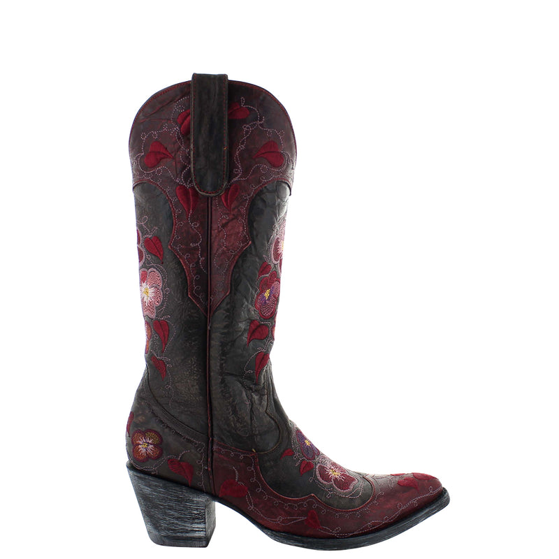 A red leather women's boot with a decorative floral pattern on the side, featuring a relaxed fit design.